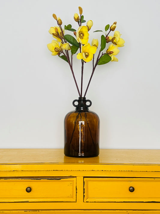 Lovely Amber Jar Vase with Tall Yellow Magnolia Stems